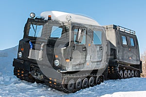 Articulated military tracked cargo vehicle on snow