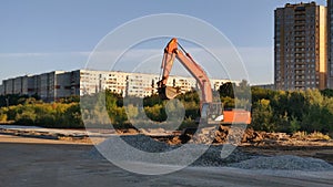 Articulated wheeled crawler excavator or bulldozer on construction site of city highway or road.