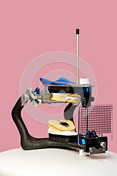 Articulator for teeth modeling on pink background