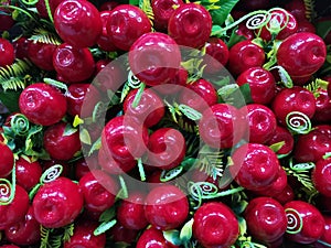 Artifial red cherry with green leaves