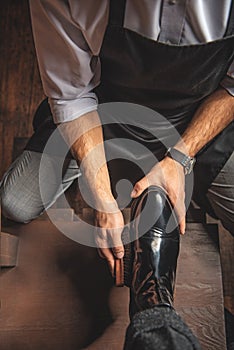 Artificer hands taking care of the leather surface