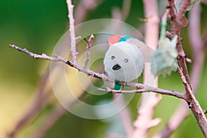 Artificial bird on pink tree branch children crafts in kindergarten