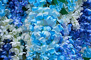 Artificial blue flowers background,the arch is decorated with delicate white flowers and blue artificial flowers