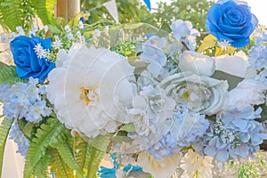 Artificial blue and white flowers decorate the arch as the backdrop in the wedding ceremony. Flowers background.