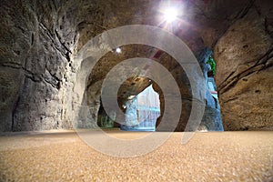 Artificial cave in waterpark with waterfall