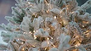 Artificial Christmas tree, Christmas lights, beautifully decorated. Close-up of LED garland decorating the tree