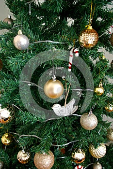 Artificial Christmas tree decorated with presents underneath