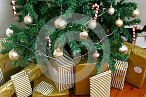 Artificial Christmas tree decorated with presents underneath