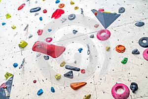 artificial climbing wall with grips and carabiners in the interior