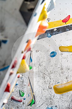 artificial climbing wall with grips and carabiners in the interior