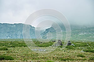 Artificial construction in the form of piles of stones in the Alpine meadows of Altai