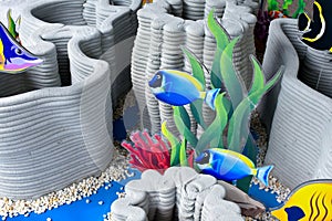 Artificial coral reef models and marine fish models are beautifully arranged to be used as props to simulate the ocean or sea photo