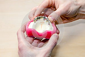 Artificial dental prosthesis on wooden table