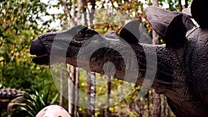 Artificial dinosaur sculpture decoration in the natural park garden