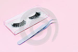 Artificial false fluffy eyelashes with tweezers.
