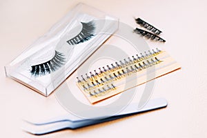 Artificial false fluffy eyelashes with tweezers.