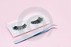 Artificial false fluffy eyelashes with tweezers.