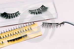 Artificial false fluffy eyelashes with tweezers.