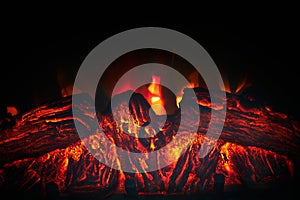Artificial fireplace. Burning logs. Decorative fire