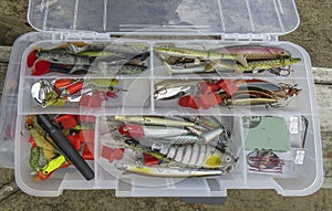 Artificial fish bait. Colorful Fishing Lures. Tackles, spoons and wobblers in box for catching or fishing of predatory fish. Close