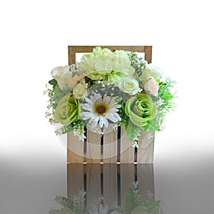 Artificial flower bouquet decorated in basket isolated on white