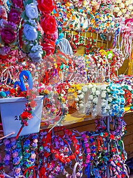 Artificial flower crowns presented for sale at a fair stall photo