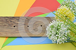 artificial flower on orange, red, blue and green background give romantic look concept with two ladybird a