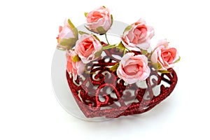 Artificial flower and red heart on white background, wedding interior detail close up