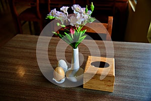 Artificial flowers in a glass made flower vase