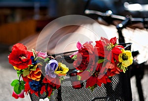 Artificial flowers on a metal bike basket