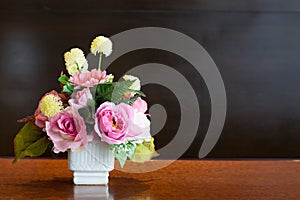 Artificial Flowers sets in white vase, background chalkboard