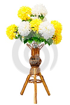 Artificial flowers and wicker wooden vase