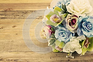 Artificial flowers on wooden background, Vintage effect