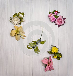 Artificial flowers on a wooden board