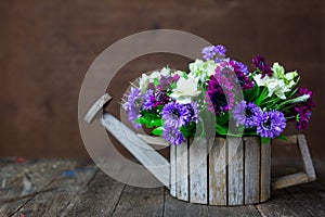 Artificial flowers on wooden table