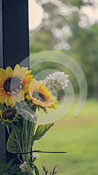 Artificial Flowers Zip Tied To A Post