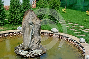 An artificial garden fountain with a large bowl
