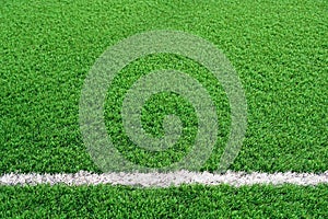 Artificial grass of football field with white stripe, Soccer corner line detail, Green astro turf for texture background