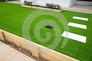 Artificial grass/lawn turf in the front yard of a modern home/residential house. photo