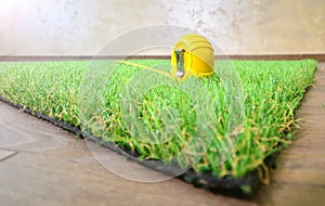 Artificial grass lie on the wooden background