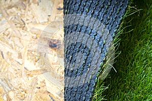 Artificial grass roll on the osb subfloor photo