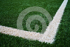 Artificial green grass with a 90 degree white line