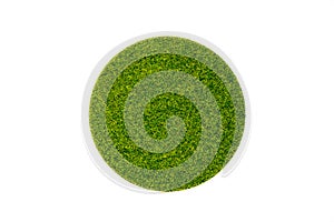 Artificial green grass in round shape on white background