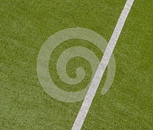 Artificial green turf texture background with white line marks