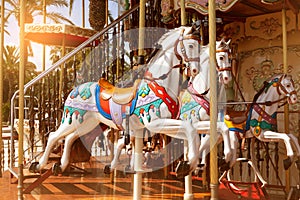 Artificial horses of a merry-go-round carousel on a sunny day