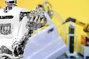 Artificial Intelligence on blurred industrial robotics working with auto part background