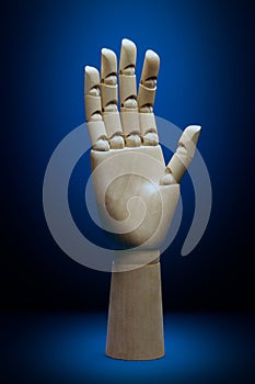 Artificial intelligence wooden hand front view on a classic blue background