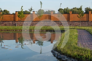 Artificial lake with lilies and stone path around the lake