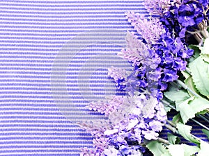 Artificial lavender flowers bouquet on fabric background