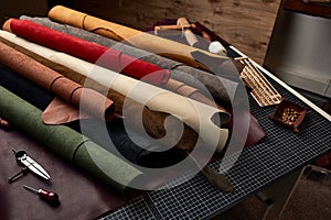 Artificial leather samples on a cow leather background. Top view.